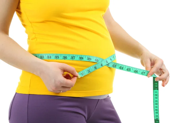 Pregnant woman measuring her belly isolated on white — Stock Photo, Image