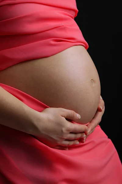 Mujer embarazada con material de coral de cerca —  Fotos de Stock