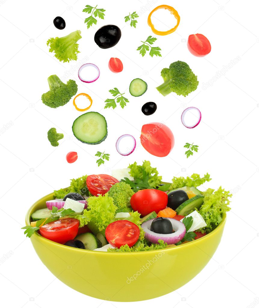 Fresh mixed vegetables falling into bowl of salad isolated on white