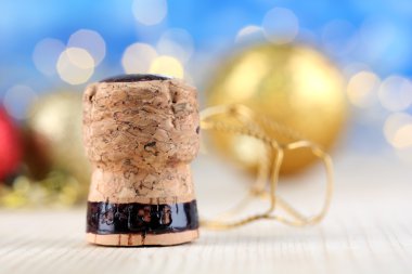 Champagne cork on Christmas lights background clipart