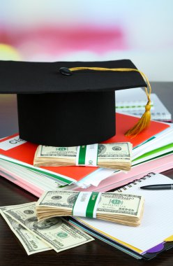 Money for graduation or training on wooden table close-up clipart