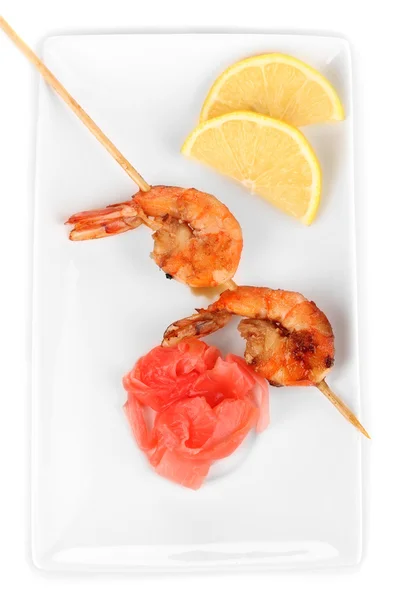 Shrimp skewers on plate with ginger and lemon isolated on white — Stock Photo, Image