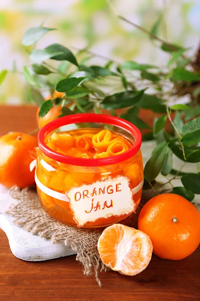 Orange jam with zest and tangerines, on brown wooden table — Stock Photo, Image