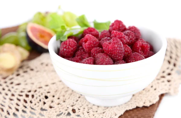 Raspberries in small bowl on napkin isolated on white — Stock Photo, Image