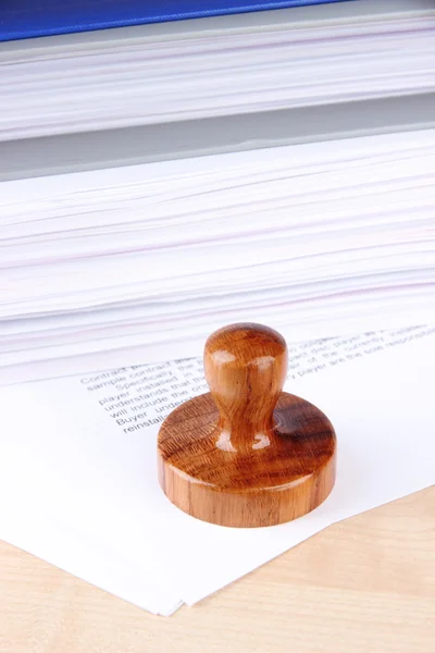 Wooden stamp and papers on table — Stock Photo, Image