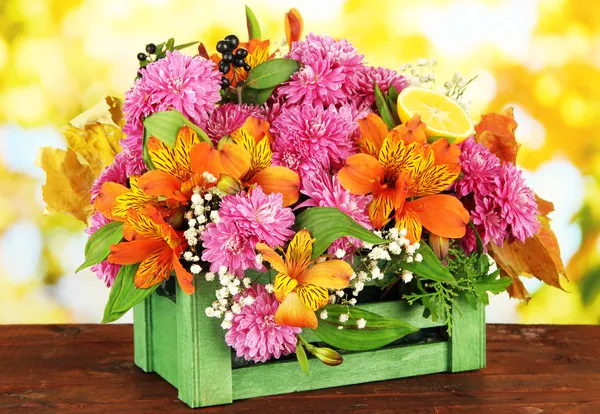 Flowers composition in crate on table on bright background — Stock Photo, Image