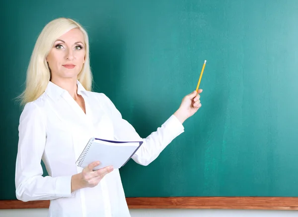 School teacher near blackboard in classroom — Stock Photo, Image