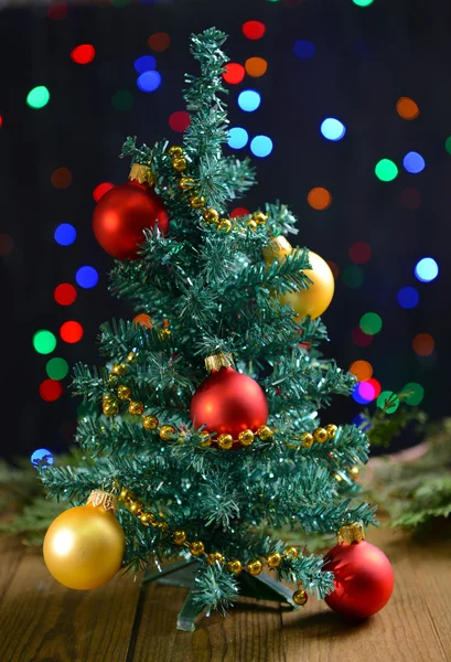 Decorative Christmas tree on table on bright background — Stock Photo, Image