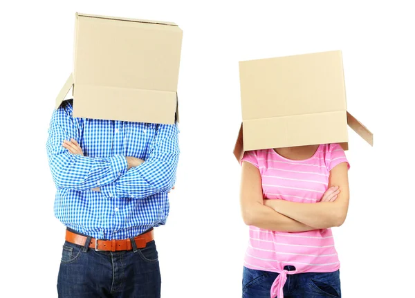 Couple with cardboard boxes on their heads isolated on white — Stock Photo, Image