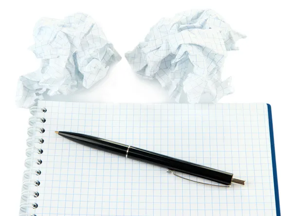 Crumpled paper balls with notebook and pen isolated on white — Stock Photo, Image