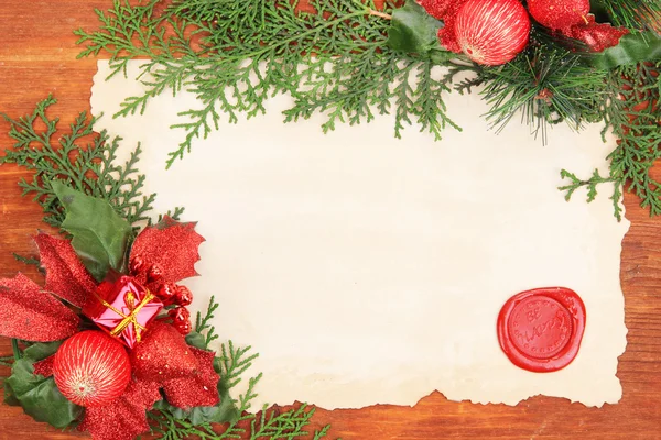 Frame with vintage paper and Christmas decorations on wooden background — Stock Photo, Image