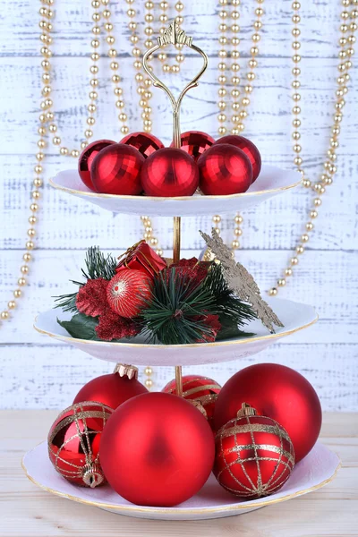 Christmas decorations on dessert stand, on wooden background — Stock Photo, Image