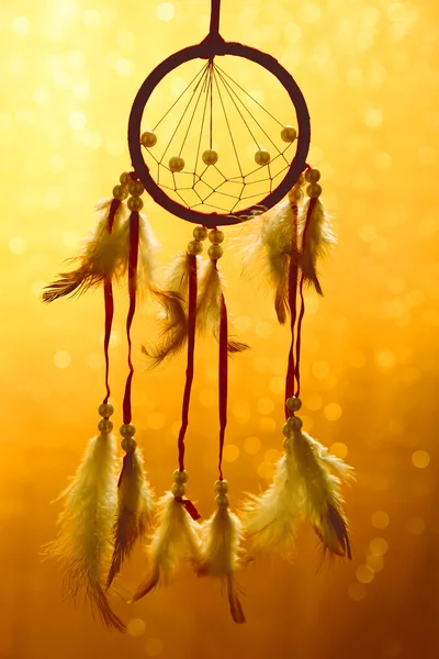 Beautiful dream catcher on yellow background with lights — Stock Photo, Image