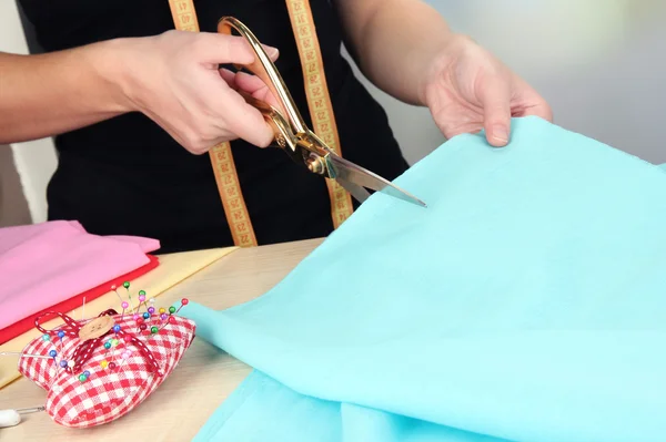 Cutting fabric with tailors scissors — Stock Photo, Image