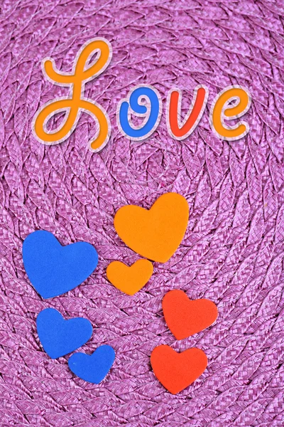 Hearts made of felt on purple background — Stock Photo, Image