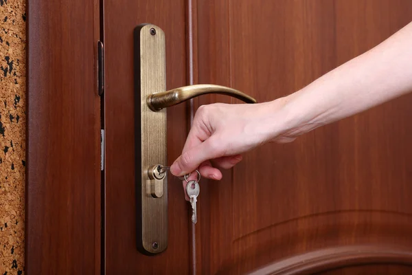 Locking up or unlocking door with key in hand — Stock Photo, Image