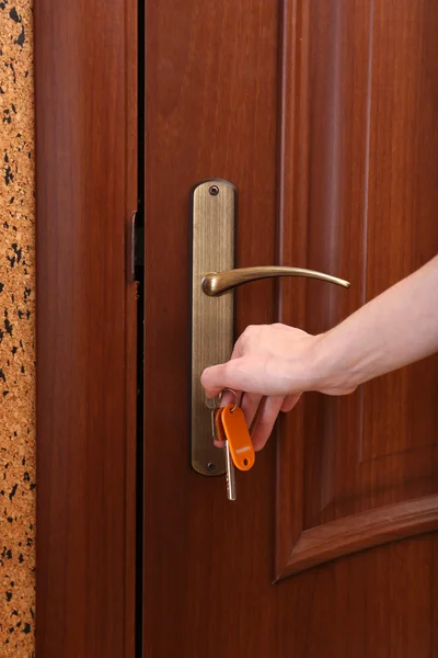 Locking up or unlocking door with key in hand — Stock Photo, Image