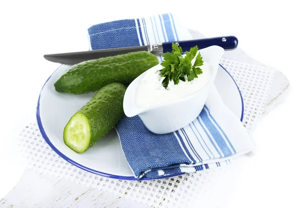 Cucumber yogurt in sauceboat, on color napkin, isolated on white — Stock Photo, Image