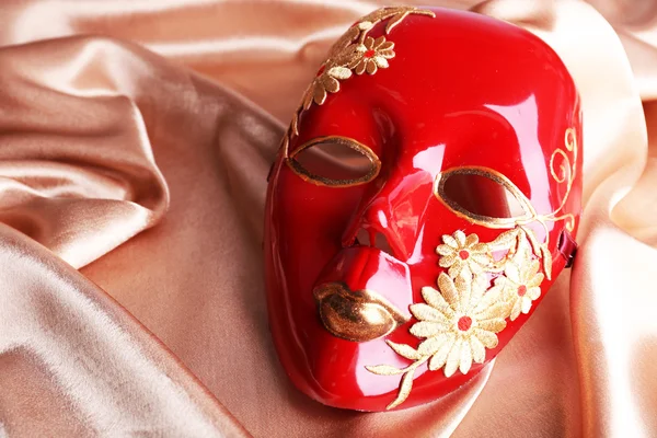 Mask on golden fabric background — Stock Photo, Image