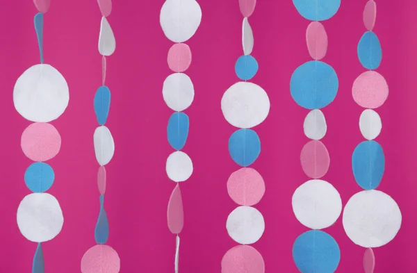 Decorative felt garland on pink background — Stock Photo, Image