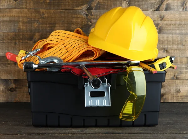 Black toolbox with tools on wooden background — Stock Photo, Image