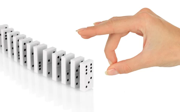 Hand pushing dominoes isolated on white — Stock Photo, Image