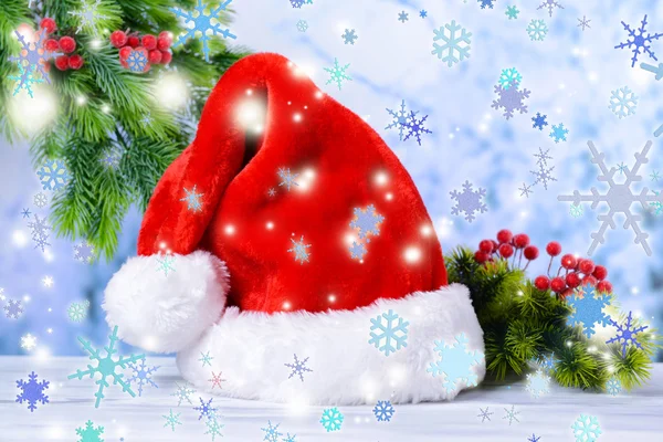Composition with Santa Claus red hat and Christmas decorations on light background — Stock Photo, Image
