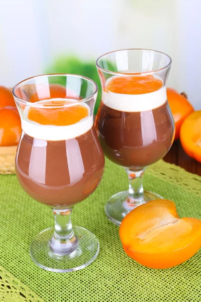 Dessert of chocolate and persimmon on table on light background — Stock Photo, Image