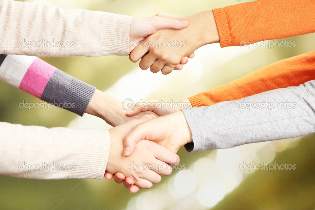 Handshakes on bright background