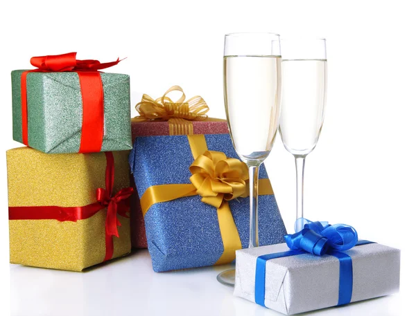 Glasses of champagne with gift boxes isolated on white — Stock Photo, Image