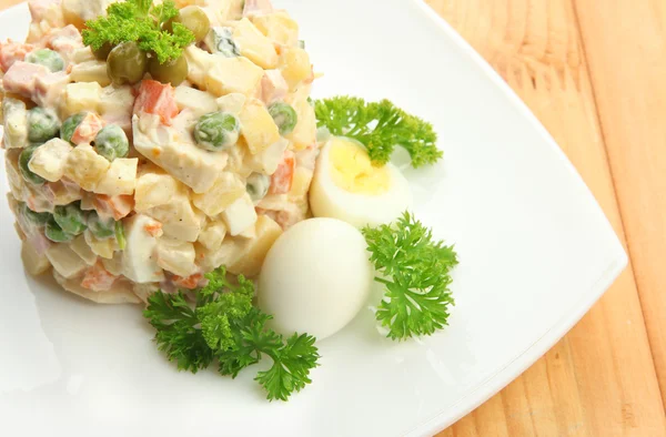 Russian traditional salad Olivier, on wooden background — Stock Photo, Image