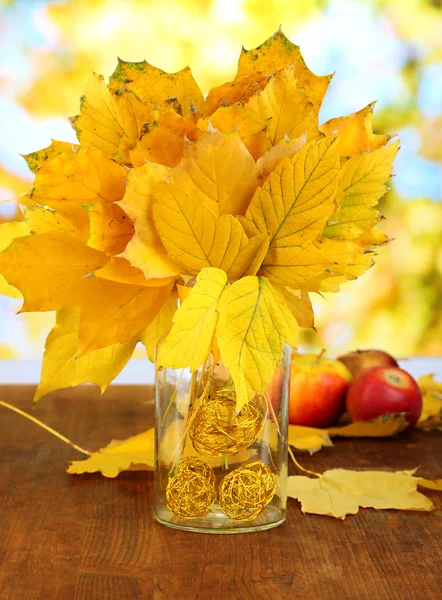 Bright autumn leafs in vase on wooden table on natural background — Stock Photo, Image