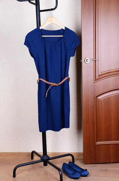 Dress hanging on hanger near door — Stock Photo, Image