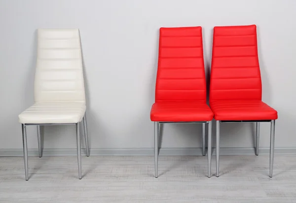 Modern color chairs on wall background — Stock Photo, Image