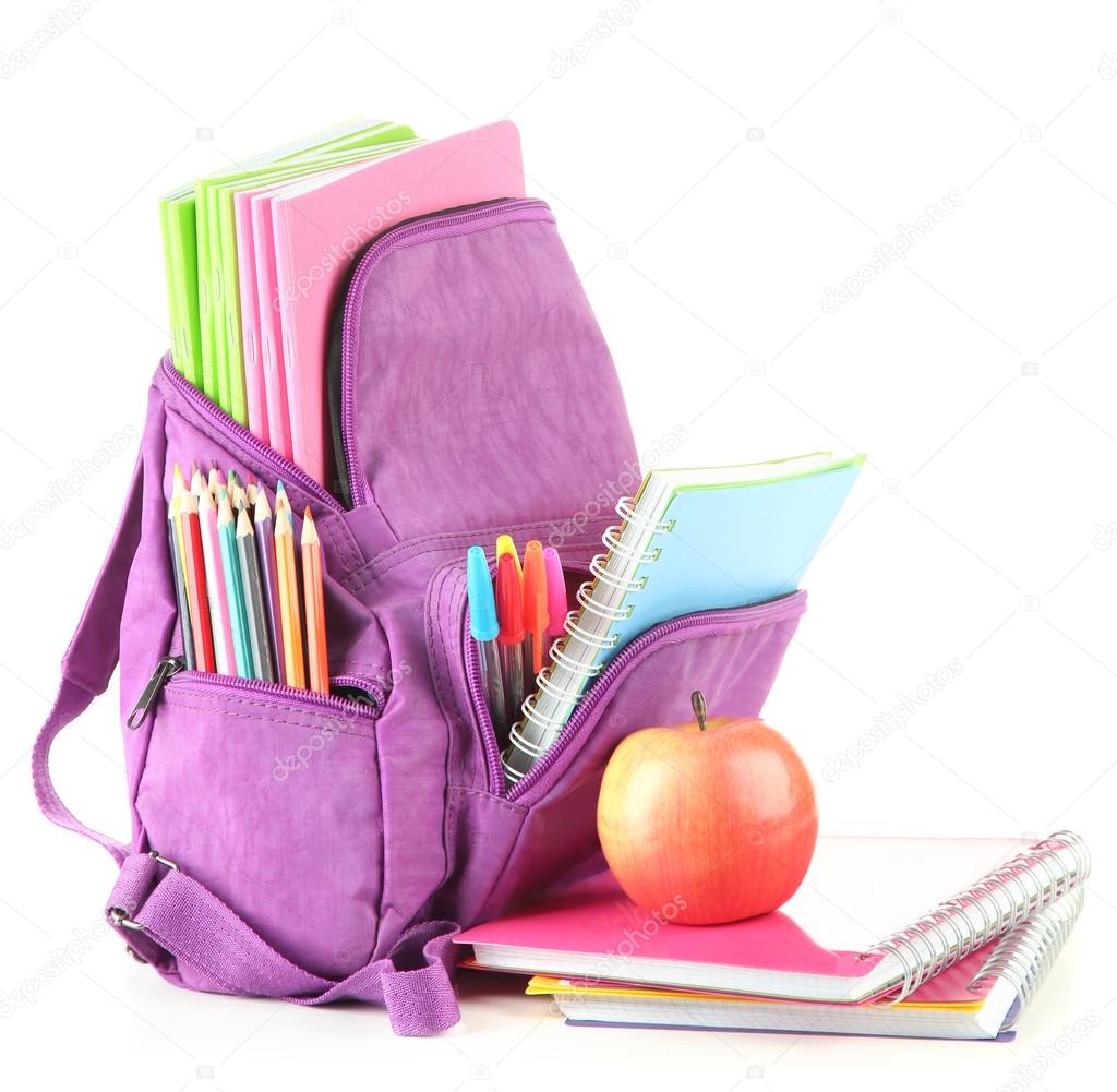 Purple backpack with school supplies isolated on white