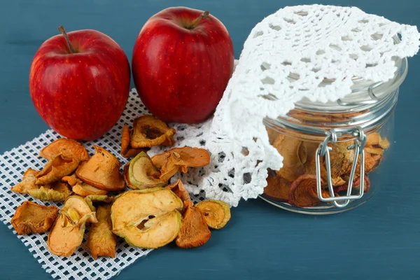 Dried apples in glass jar, on color wooden background — Stock Photo, Image