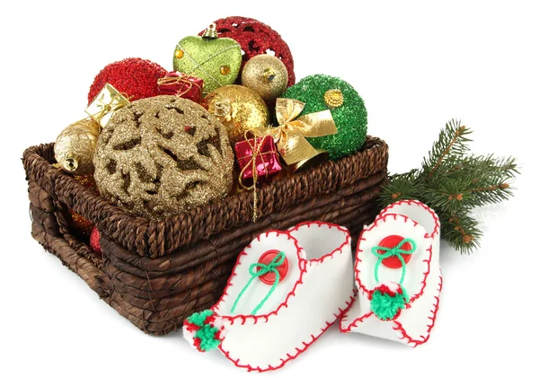 Christmas decorations in basket and shoes isolated on white — Stock Photo, Image