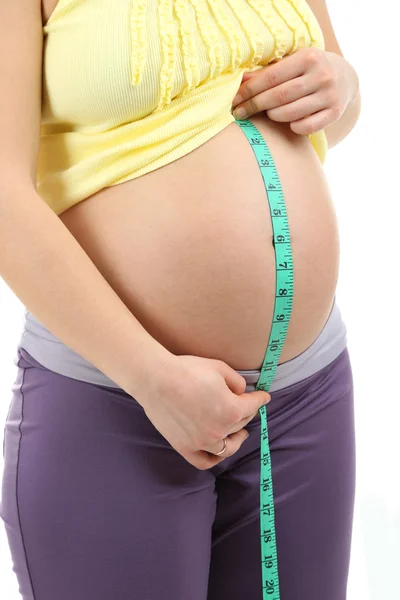 Pregnant woman measuring her belly close up — Stock Photo, Image