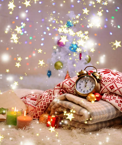 Composition with plaids, candles and Christmas decorations, on white carpet on bright background — Stock Photo, Image