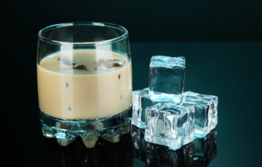 Baileys liqueur in glass on blue background clipart