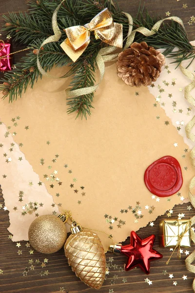 Frame with vintage paper and Christmas decorations on wooden background — Stock Photo, Image