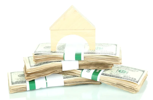 Wooden house on packs of dollars isolated on white — Stock Photo, Image