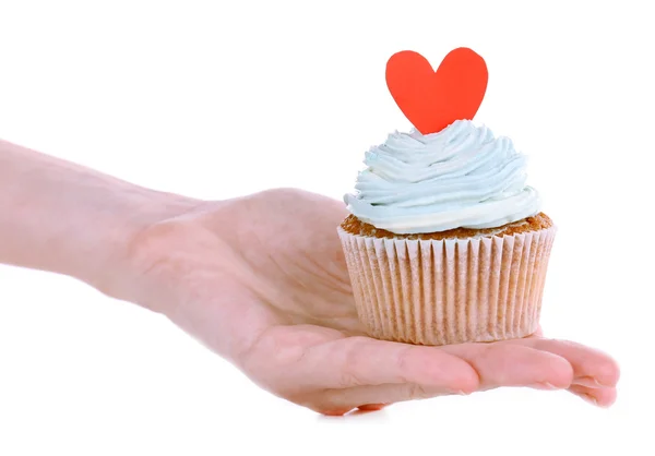 Sabroso cupcake con crema de mantequilla en mano femenina, aislado en blanco —  Fotos de Stock