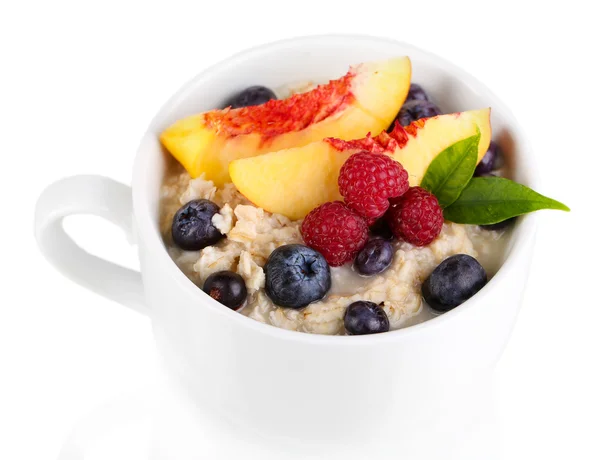 Oatmeal in cup with berries isolated on white — Stock Photo, Image