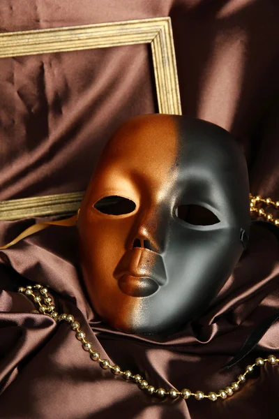 Mask on brown fabric background — Stock Photo, Image