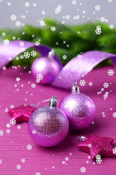 Christmas balls on fir tree, on color background — Stock Photo, Image