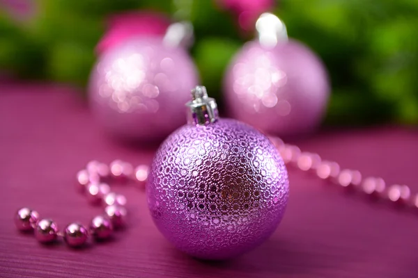 Christmas balls on fir tree, on color background — Stock Photo, Image