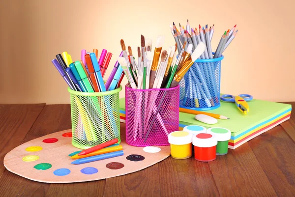 Composition of various creative tools on table on beige background — Stock Photo, Image