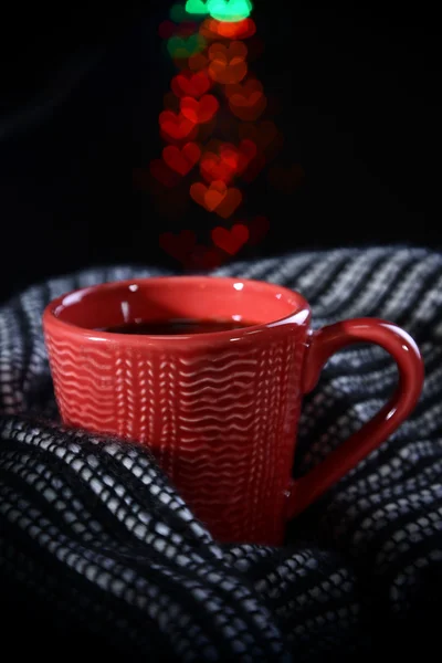 Cup of coffee with plaid on dark background — Stock Photo, Image