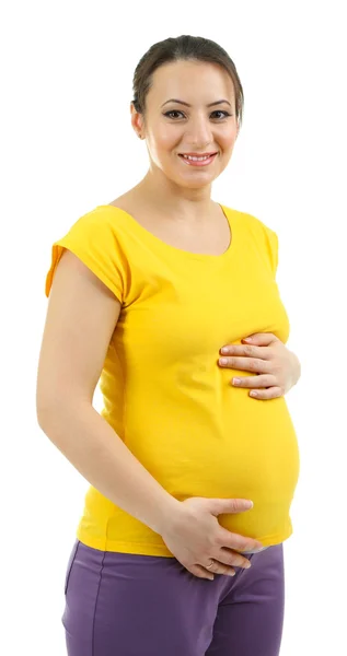 Красивая молодая беременная женщина прикасается к животу, изолированному на белом — стоковое фото